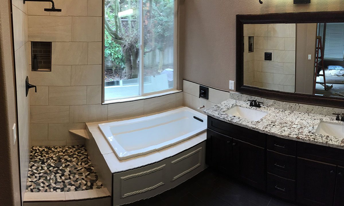 Renovated bathroom with soaking tub and tiled shower